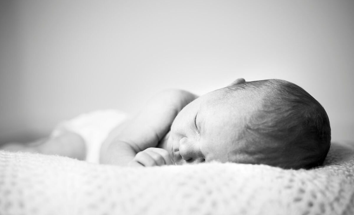 Black and white photo of a sleeping baby