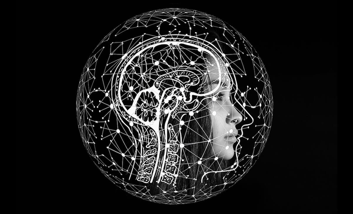 women inside an image of a brain outline covered by a sphere of geometric shapes